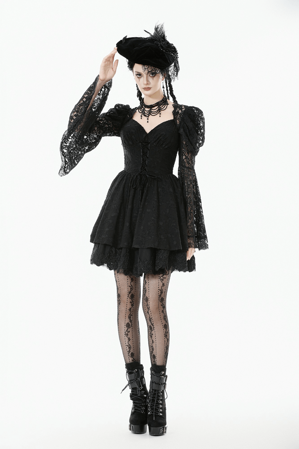 Black Lace-Up Gothic Mini Dress with Bell Sleeves worn by a model, featuring ruffled sleeves and stylish accessories.
