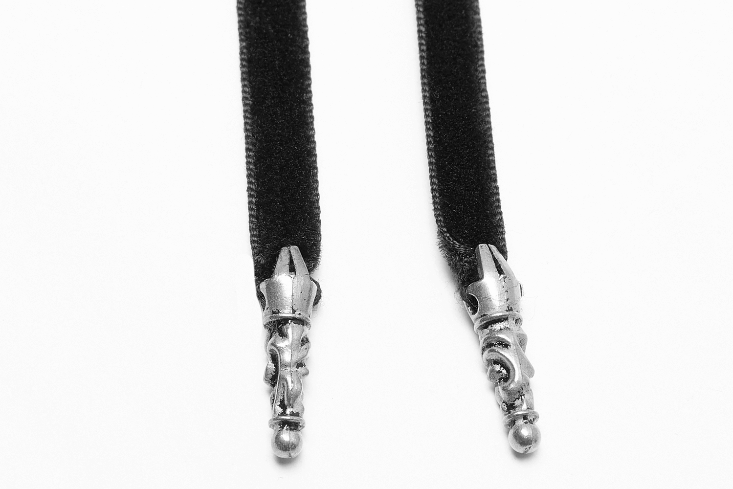 Black velvet straps with ornate silver clasps, perfect for adding elegance to any outfit or accessory.