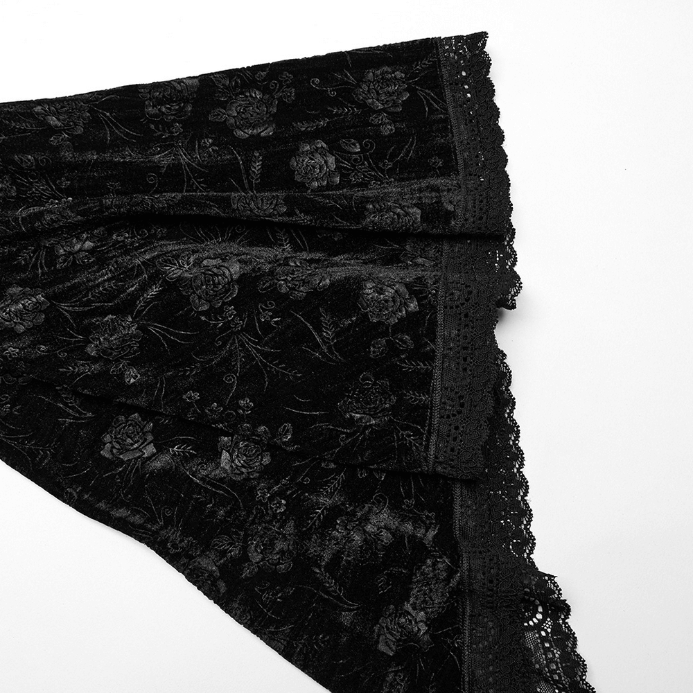 Close-up of black velvet lace with rose patterns and delicate scalloped edges, perfect for gothic elegance.