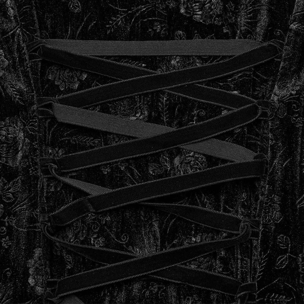 Close-up of black lace velvet roses dress showcasing intricate lacing and floral velvet texture.