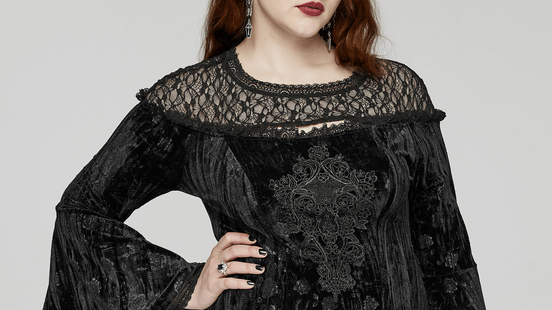 Victorian-inspired black lace velvet dress with ornate cuffs and floral pattern, embodying Gothic elegance.