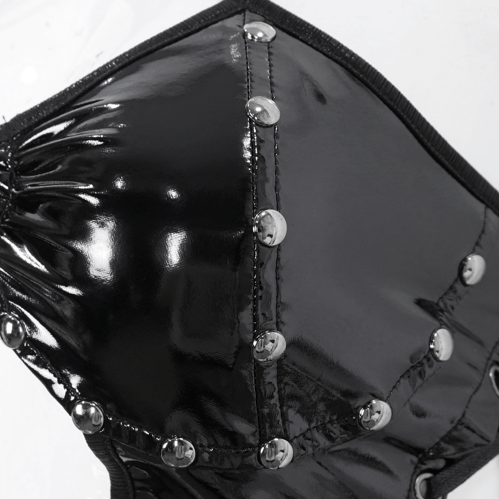 Close-up of black vinyl bodysuit detail with metallic studs and glossy finish, showcasing gothic style.