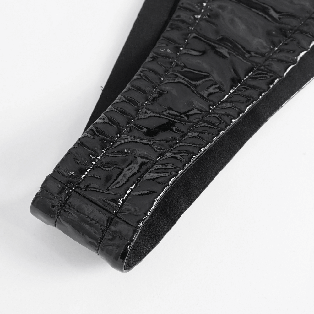 Close-up of black vinyl lacing detail on a gothic bodysuit, showcasing glossy texture and intricate design.