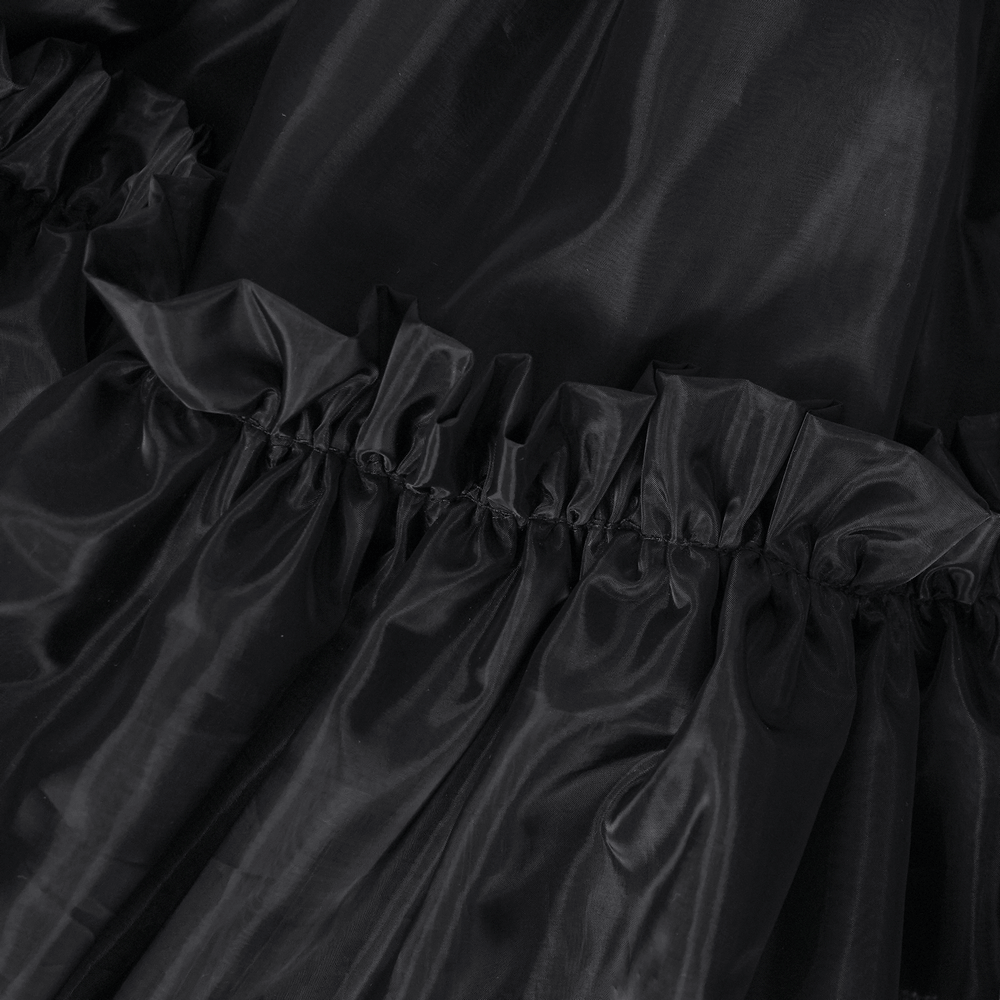 Close-up of a black layered tulle skirt featuring ruffled edges and a gathered elastic waist for a Gothic style.