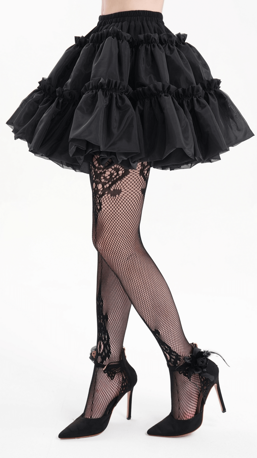 Black layered tulle skirt with ruffles, paired with lace fishnet stockings and stylish heels for a Gothic look.