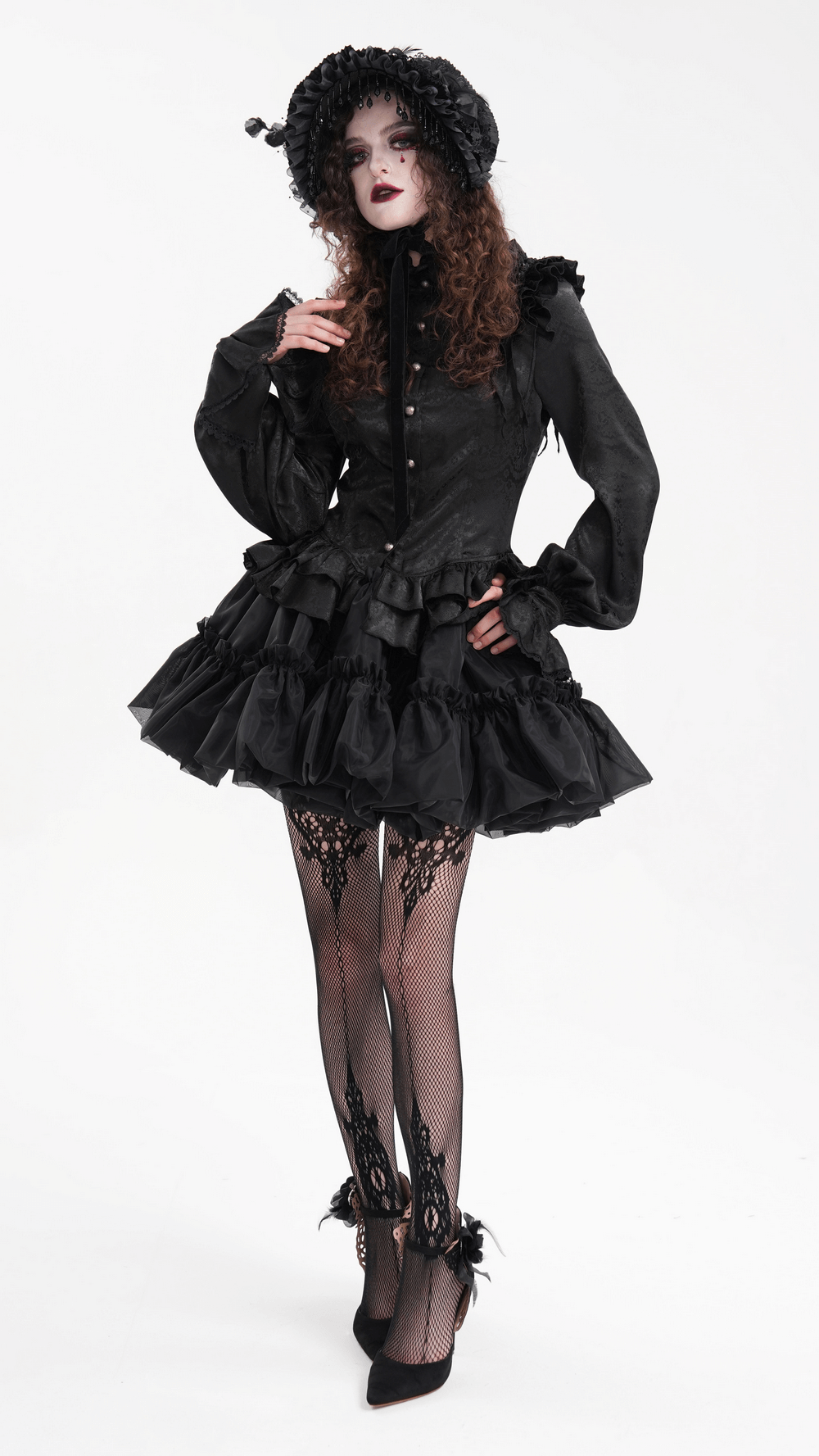 Elegant model in black layered Gothic outfit with puffy skirt and lace stockings, exuding vintage charm and dark style.