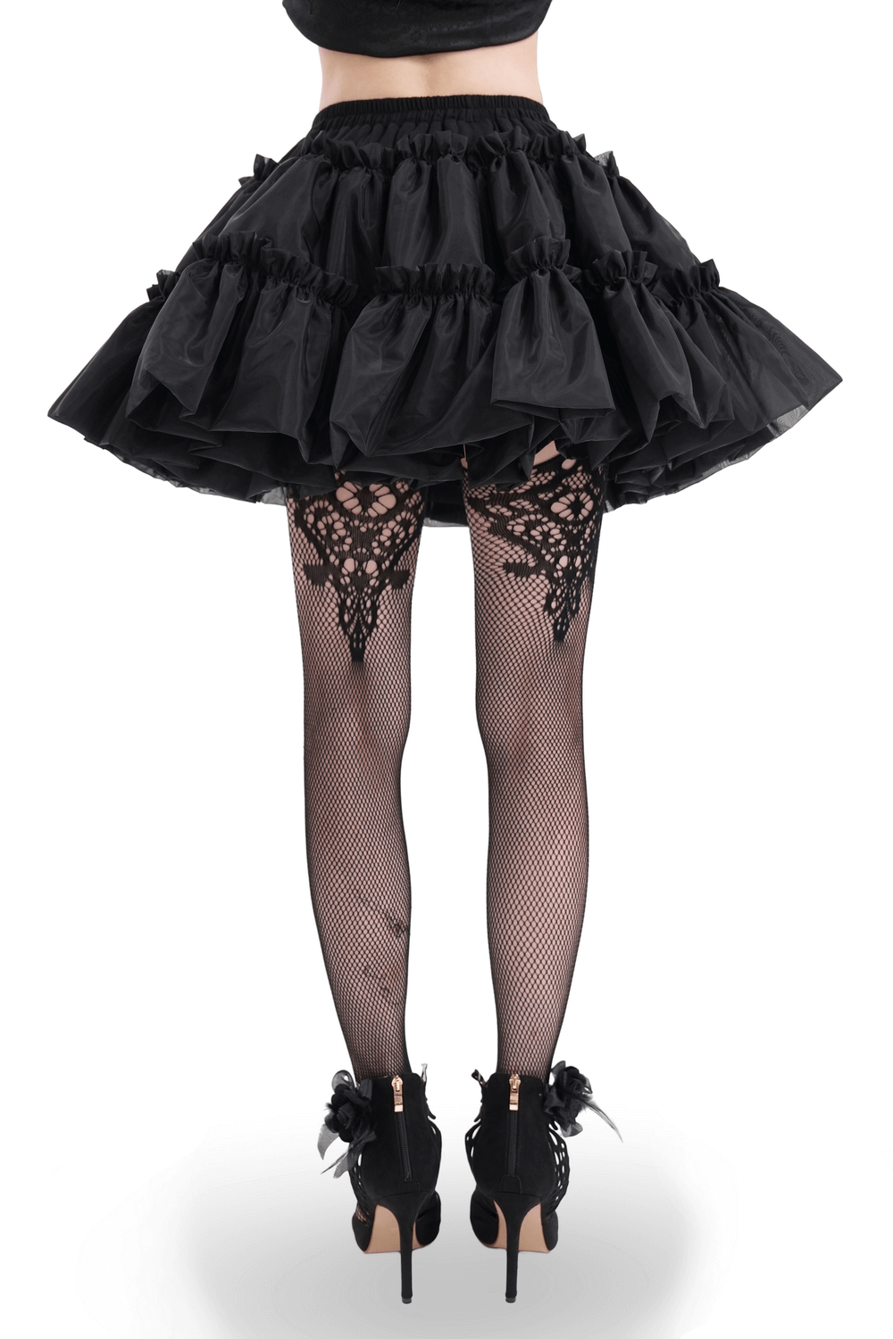 Black layered tulle skirt with ruffles, paired with intricate fishnet tights and stylish heels.