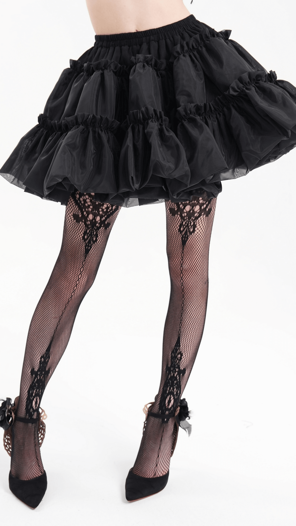Black layered gothic tulle skirt with ruffles and fishnet stockings, perfect for a dramatic outfit.