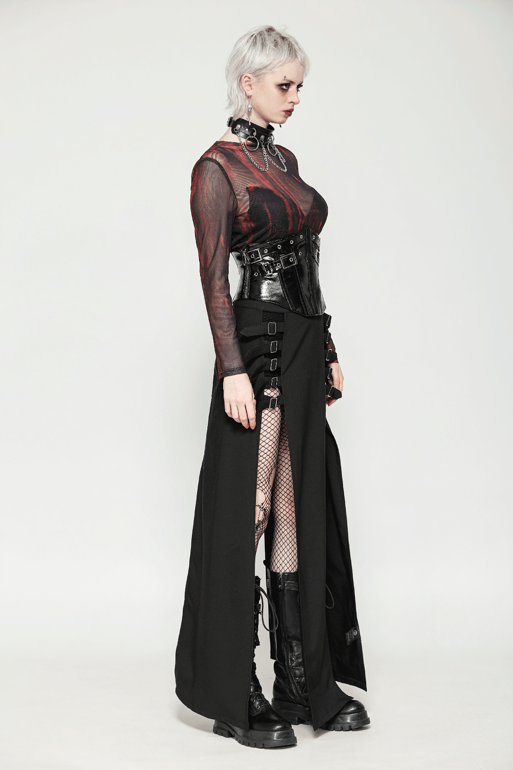 Model showcasing a black leather corset belt with buckles and rivets, paired with a stylish sheer top and skirt.