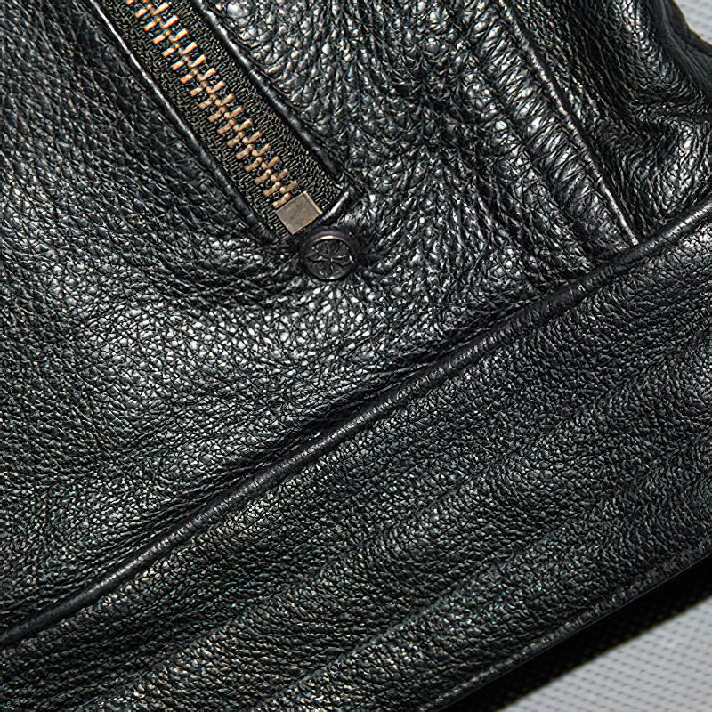 Close-up of the black genuine leather motorcycle jacket showcasing zipper and textured fabric.