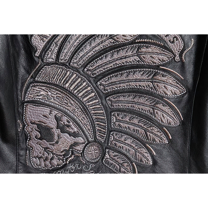 Close-up of intricate Indian skull embroidery on black leather motorcycle jacket.
