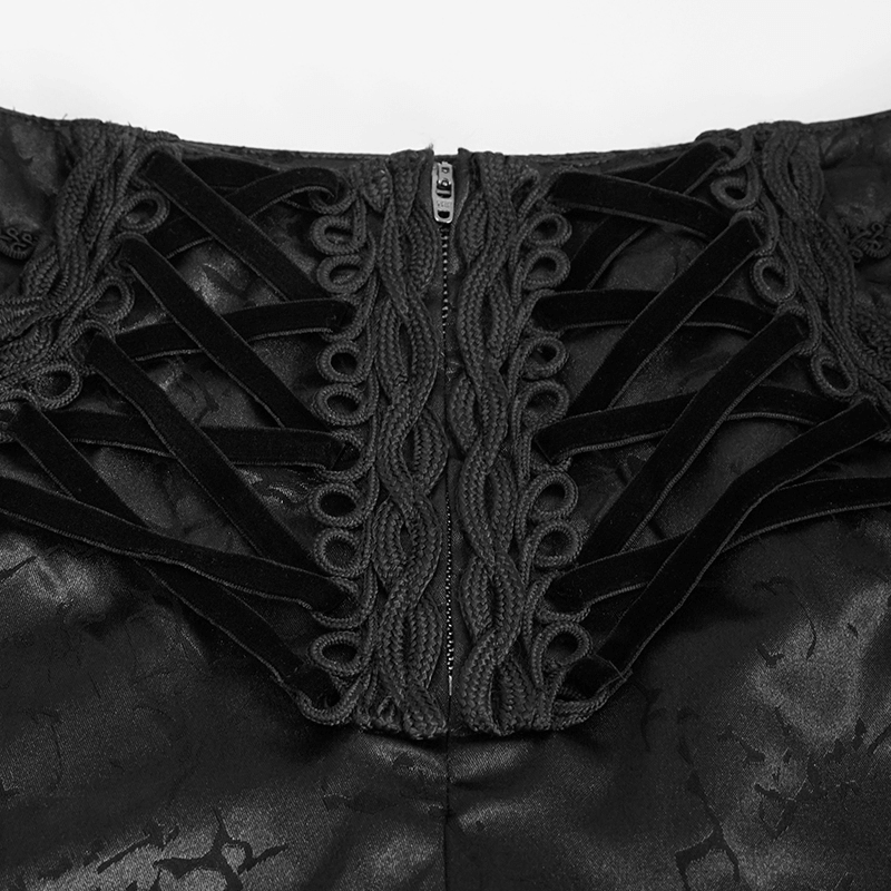 Close-up of gothic black zipper front pants showcasing intricate lace-up detail and vintage texture.