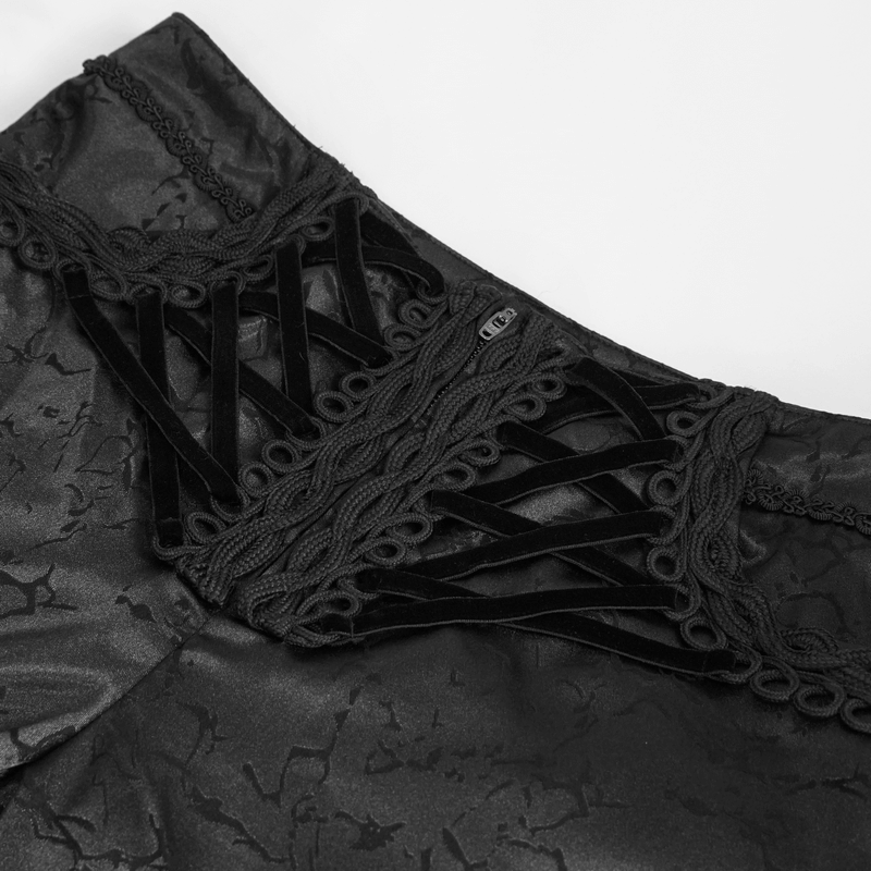 Close-up of black gothic pants featuring intricate lace-up design and vintage fabric texture.