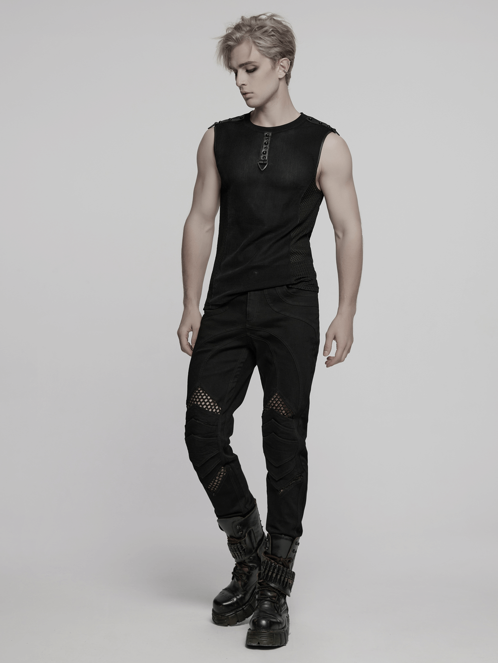 Model wearing a black mesh cyberpunk tank top with buckles and stylish black cargo pants, showcasing a sleek futuristic look.