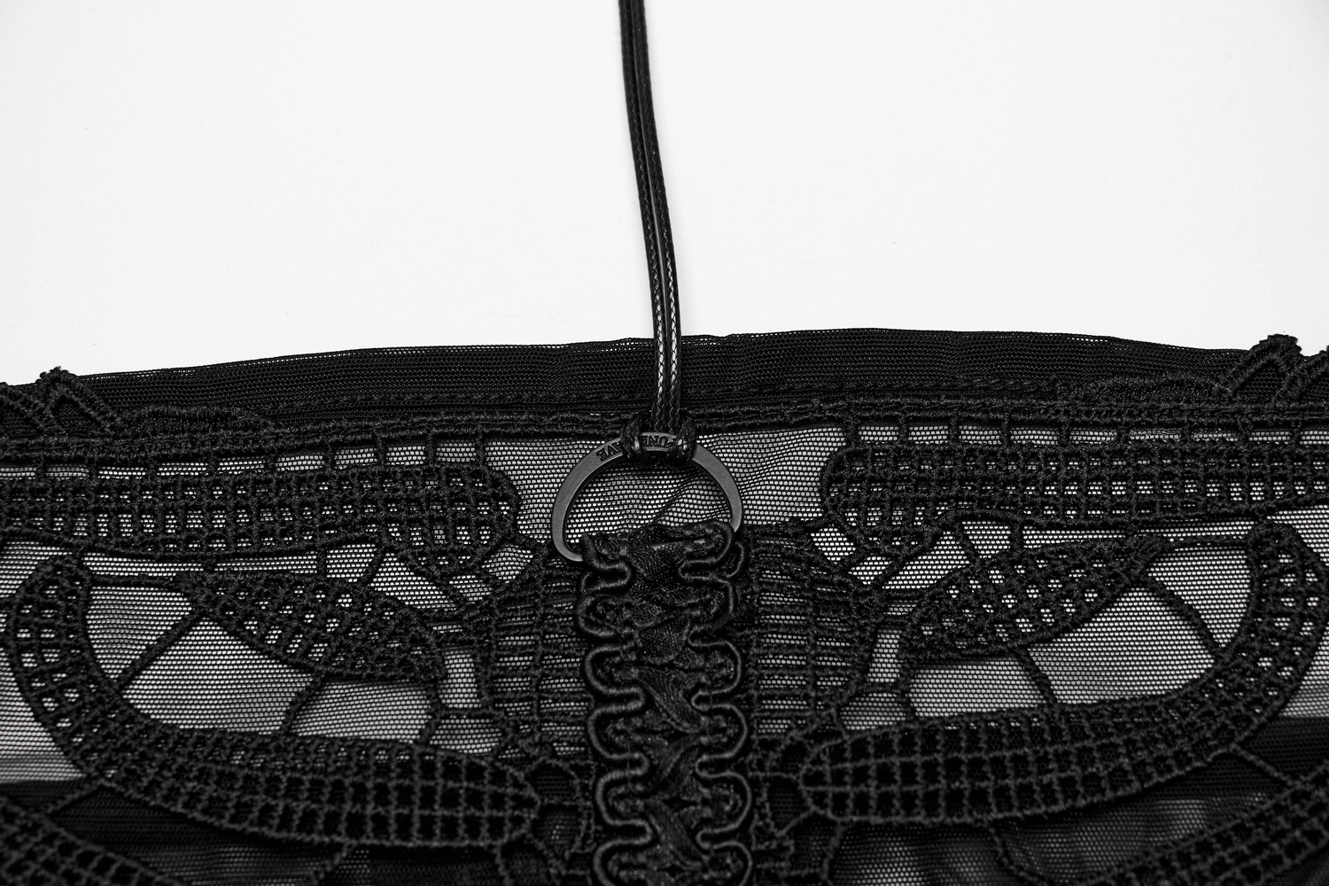 Close-up of black mesh halter top with intricate embroidered gothic skeleton details, showcasing edgy style.