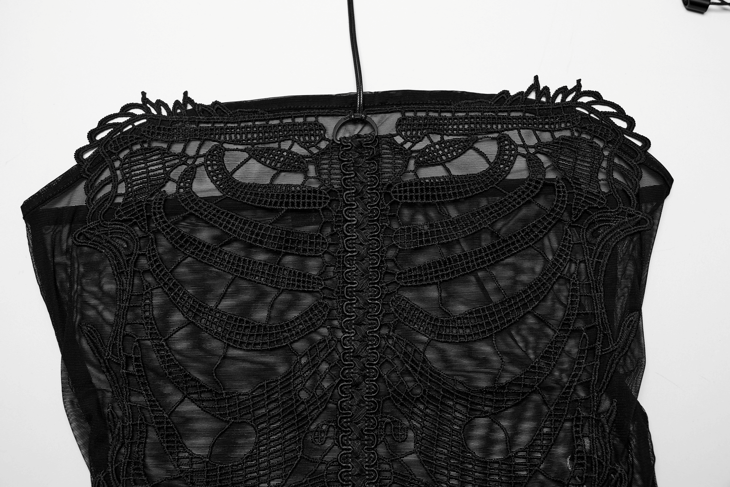 Close-up of a black mesh halter top featuring intricate embroidered gothic skeleton design.