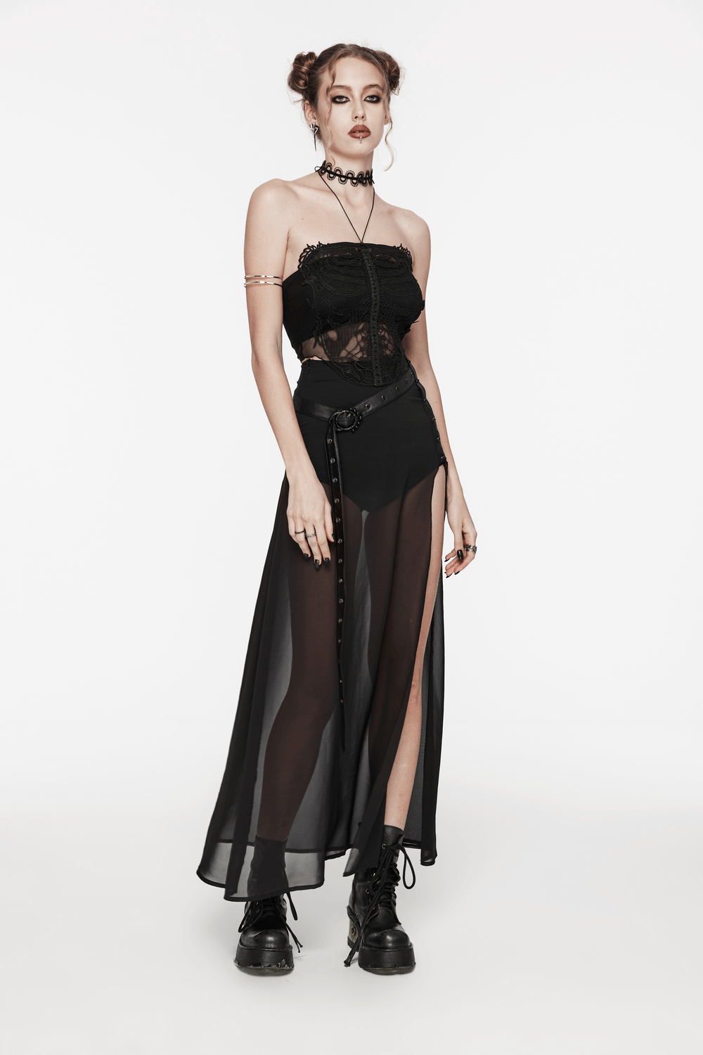 Edgy goth model in a black mesh halter top and sheer skirt, showcasing a bold, stylish look.