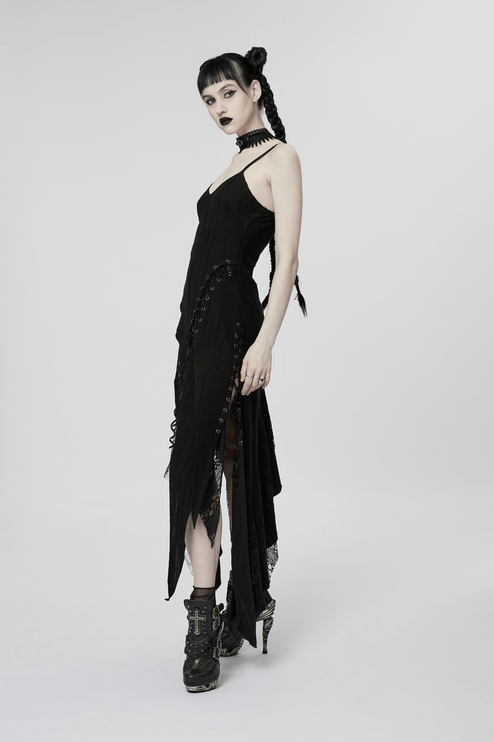 Black mesh lace asymmetrical gothic dress with edgy hem and lace splicing, worn by model in stylish boots.