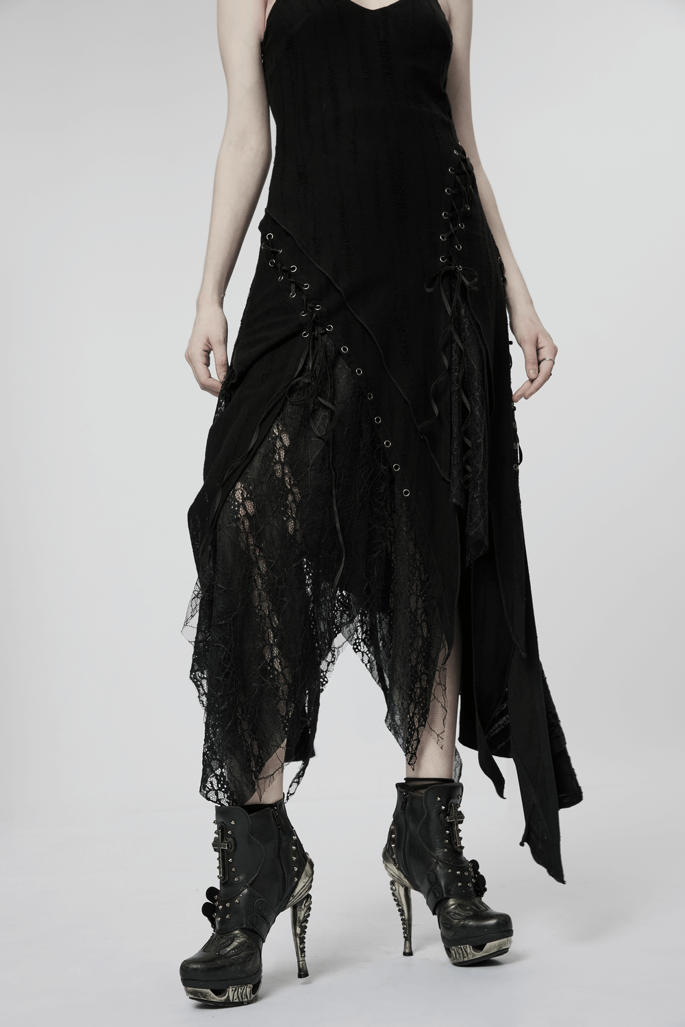 Black mesh lace asymmetrical gothic dress with pointed hem and lace details, paired with edgy black boots.