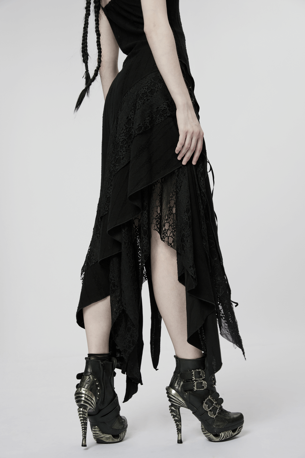 Elegant black mesh lace asymmetrical gothic dress with pointed hem and edgy silhouette, paired with stylish high-heeled boots.