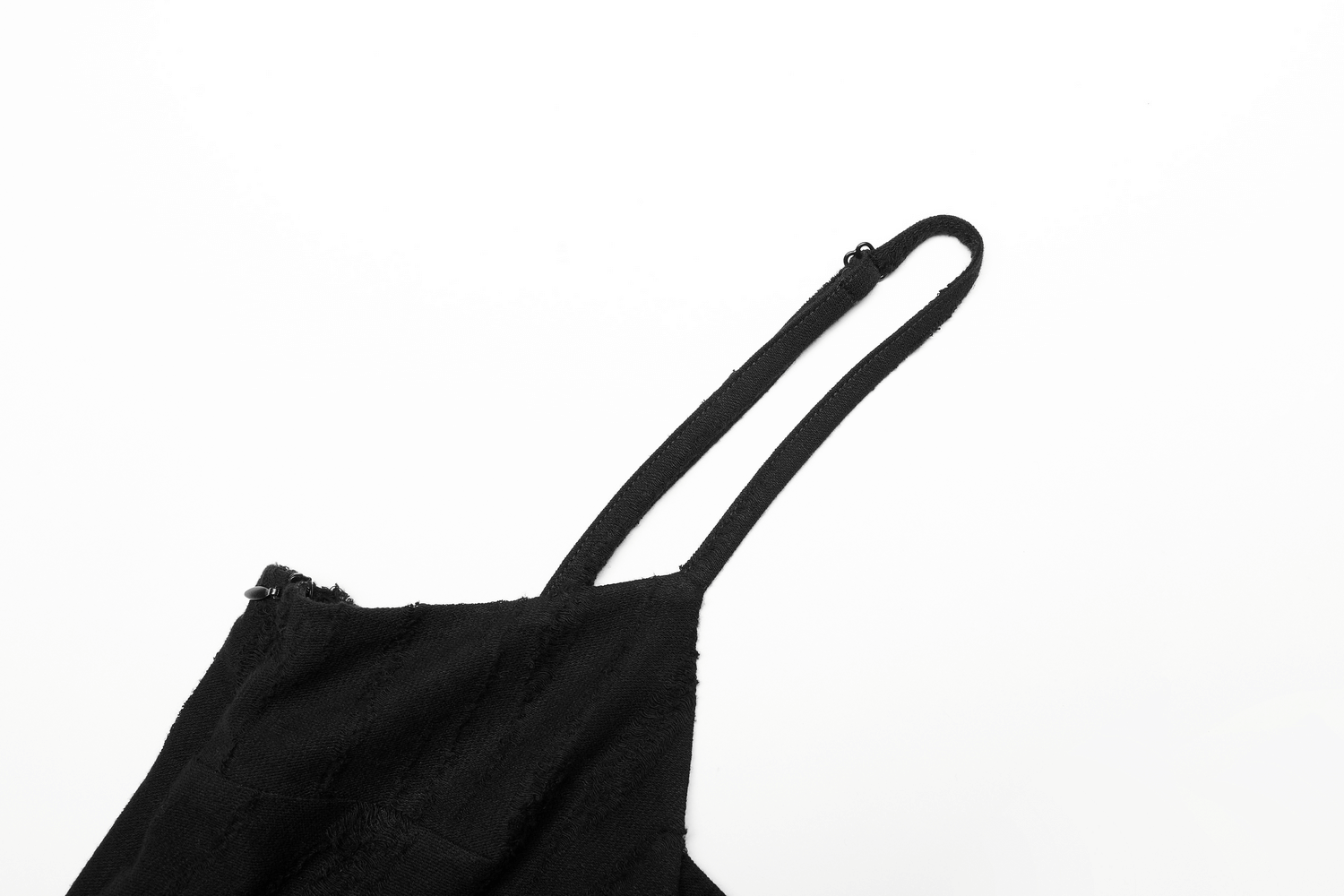 Close-up of the black mesh lace strap of an asymmetrical gothic dress showcasing textured design.