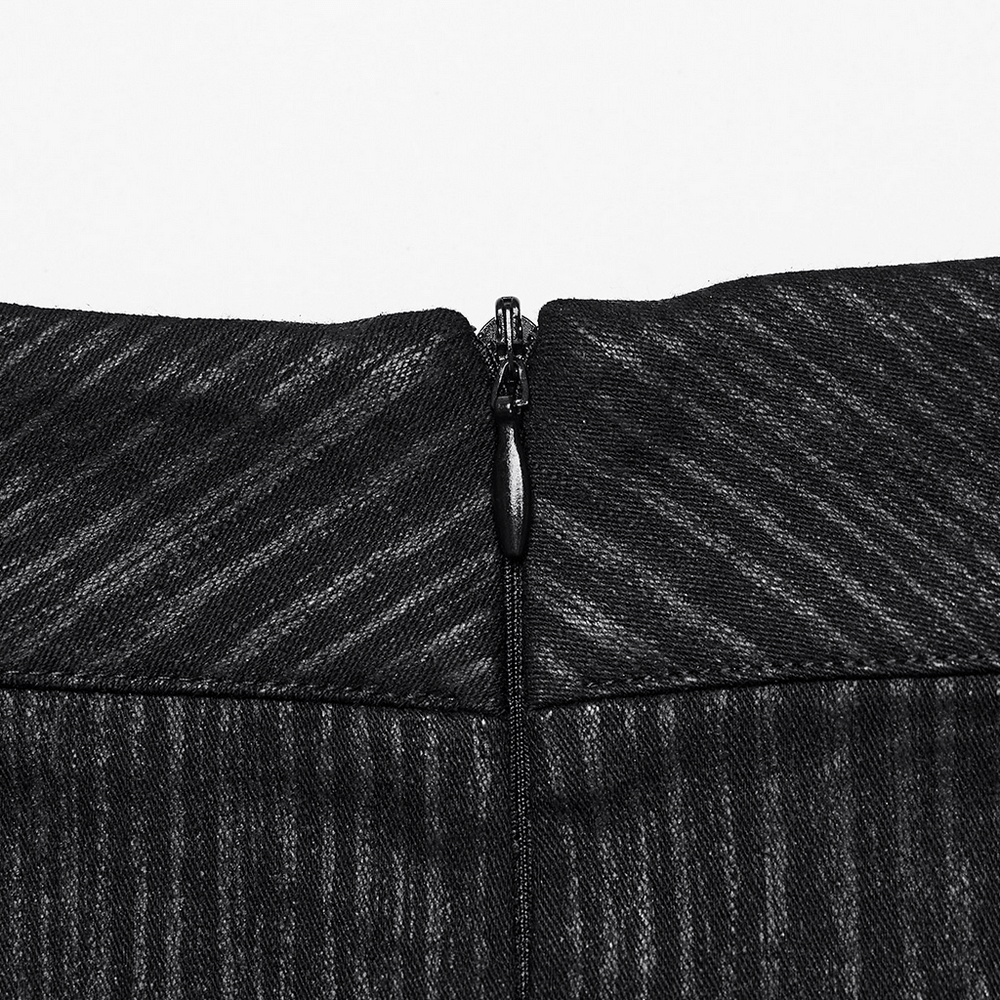 Close-up of the zip closure on a black mini skirt showcasing its textured fabric and stylish design.