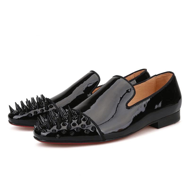 Men's black patent leather loafers with spikes, perfect for a stylish and edgy look.