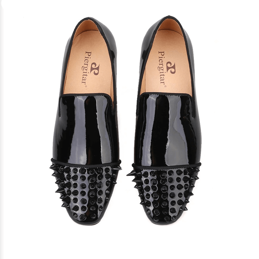 Stylish black patent leather men's loafers with spikes on the toe, perfect for casual fashion.