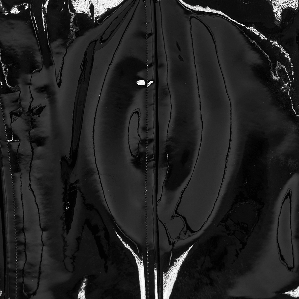 Black Patent Leather Techwear Mini Skirt with Buckles close-up of high-gloss surface and stitching.