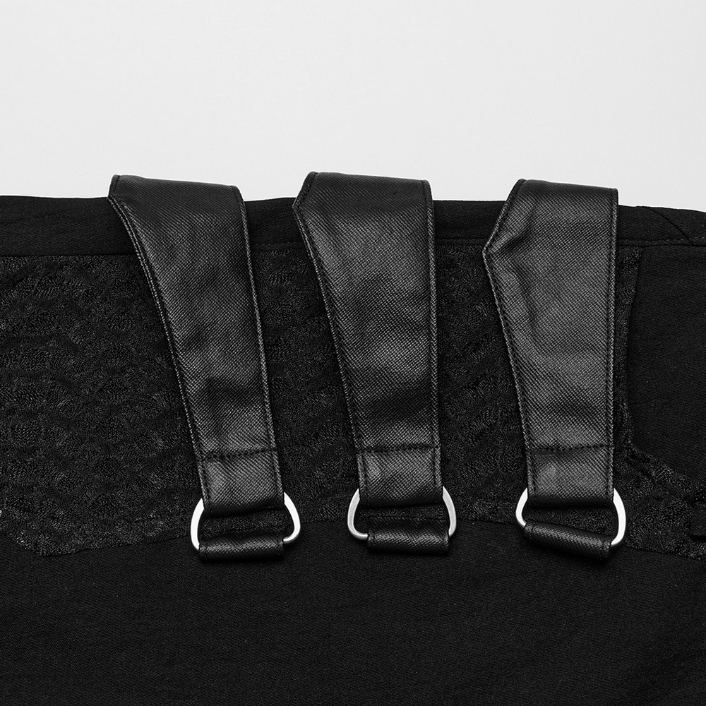Close-up of black punk asymmetric pants featuring mesh detailing and unique straps with metal rings.