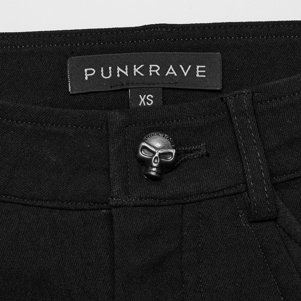 Close-up of black Punkrave pants with skull button detail and XS label, perfect for edgy punk fashion.