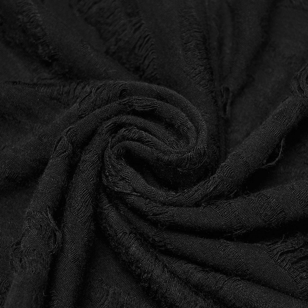 Close-up of tattered black knitted fabric, showcasing its texture and edgy style for punk fashion accessories.