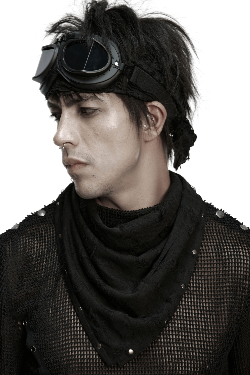 Model wearing a black punk bandana with studs, sporting goggles and a tattered knitted top for an edgy style.