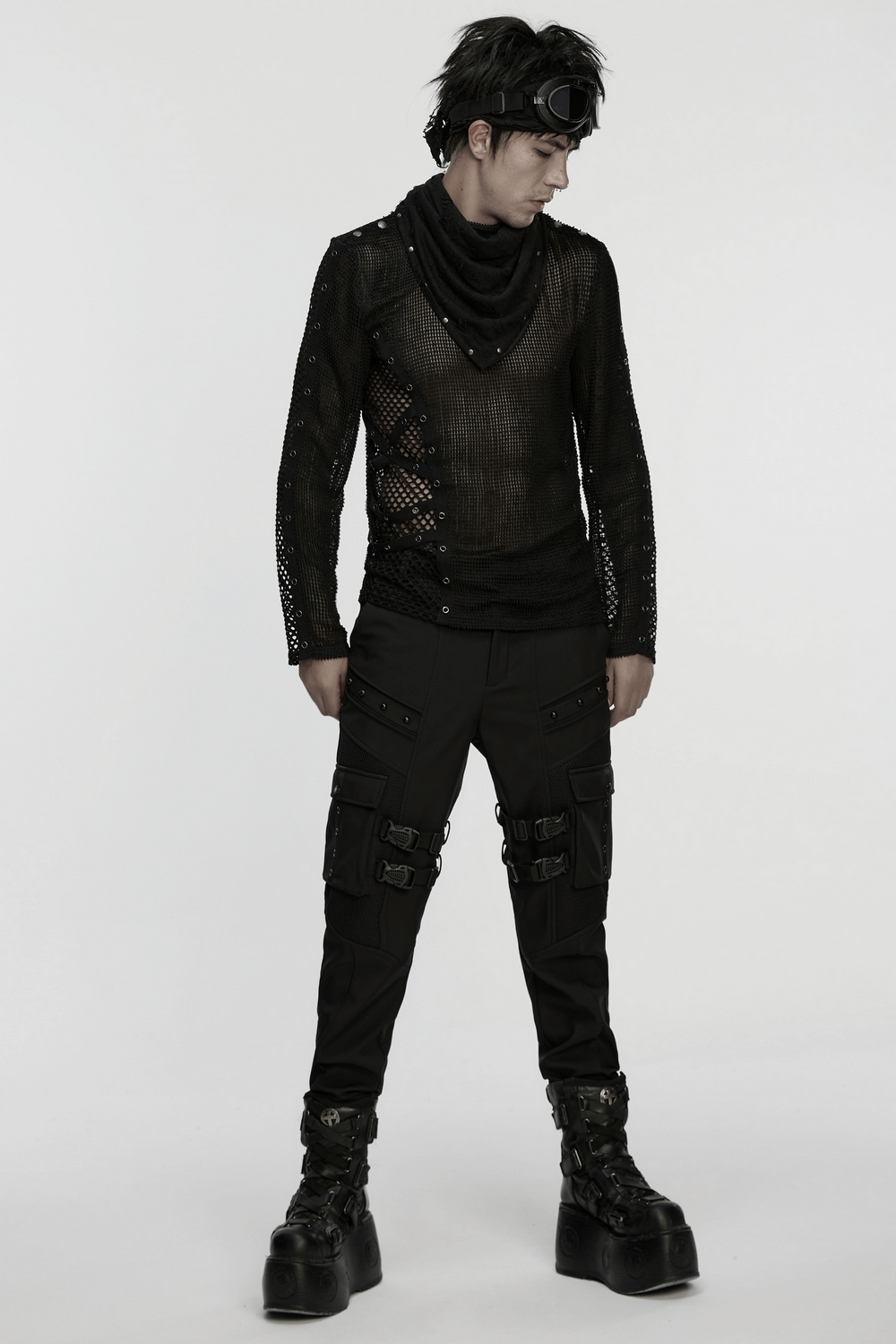 Model in edgy black punk outfit featuring mesh top and cargo pants for a rebellious street style.