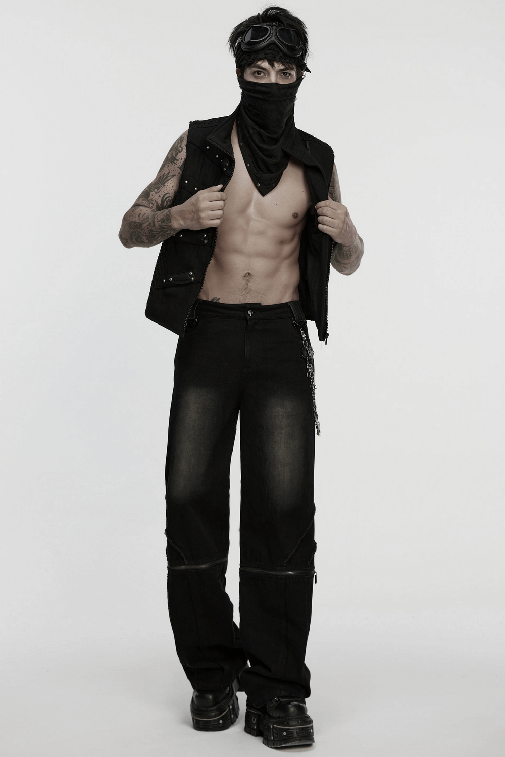 Edgy black punk bandana with studs, worn by a model with tattooed arms and stylish goggles, showcasing a rebellious look.