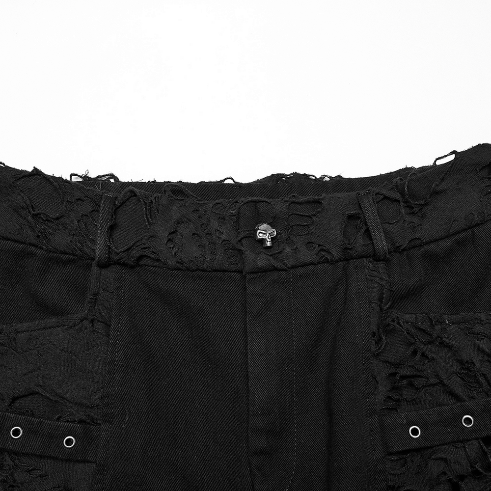 Close-up of black punk denim shorts showcasing tattered fabric and tassel details for a bold, edgy fashion statement.