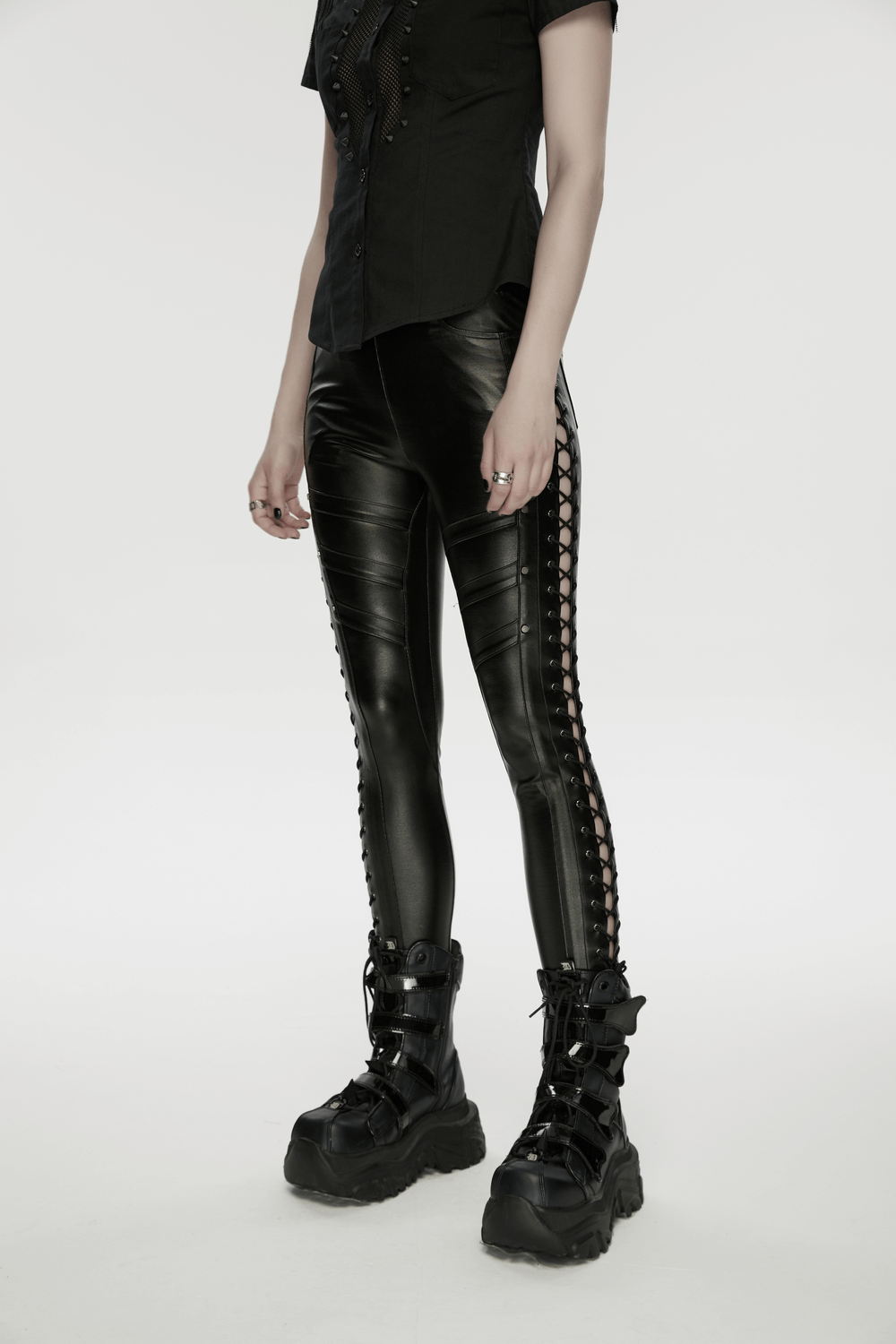 Black Punk Faux Leather Leggings with Side Drawstrings styled with a black shirt and bold combat boots.
