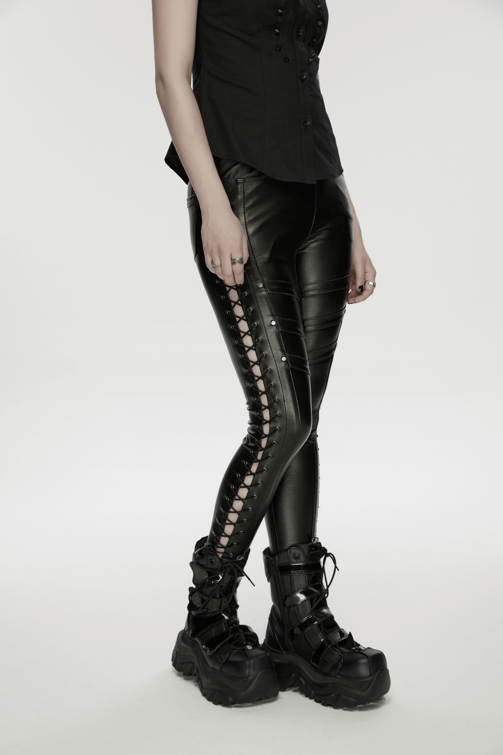 Black Punk Faux Leather Leggings with Side Drawstrings worn with stylish combat boots, showcasing edgy design and side drawstrings.