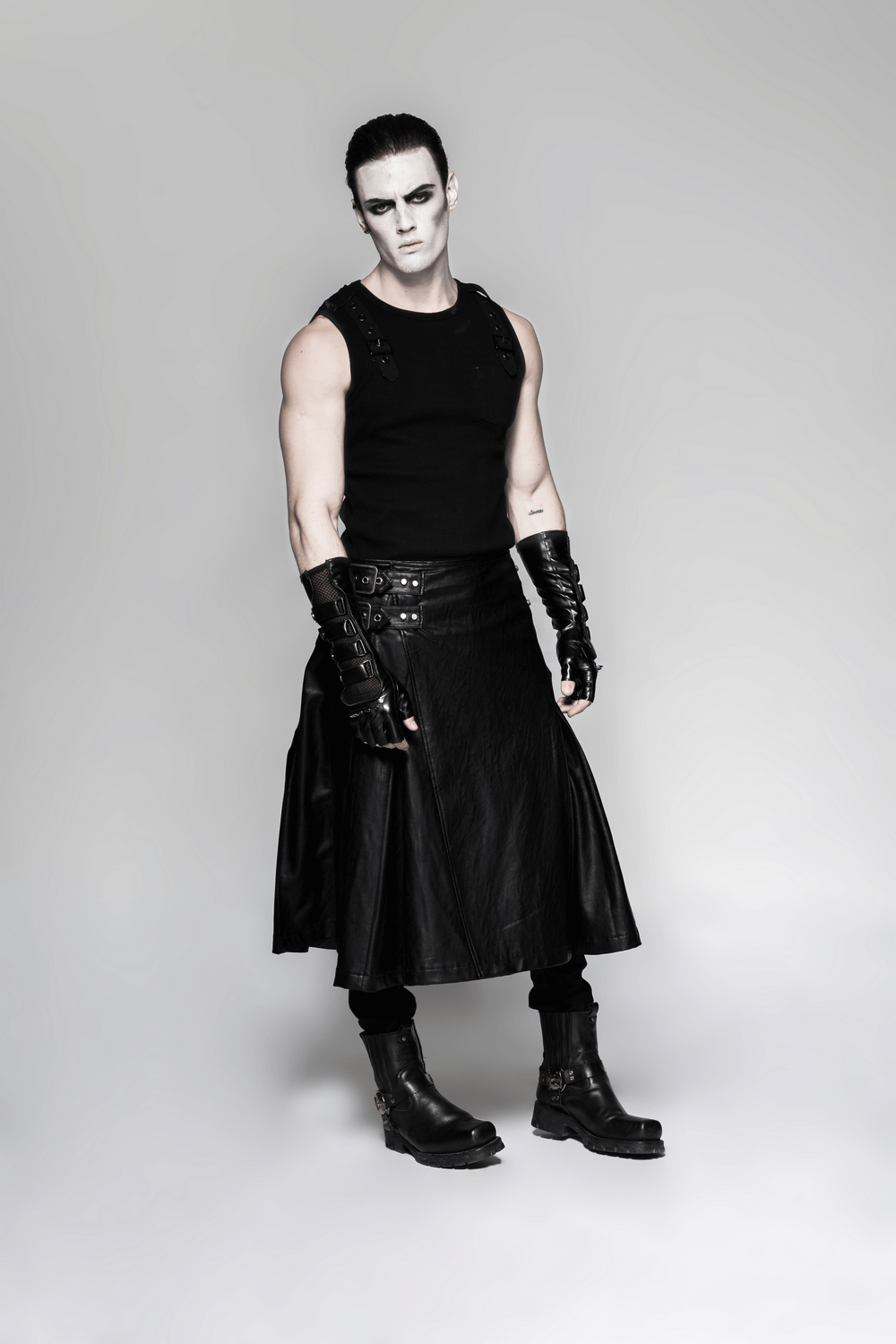 Model wearing black punk gauntlet gloves and a leather skirt, showcasing a bold, rebellious punk style.