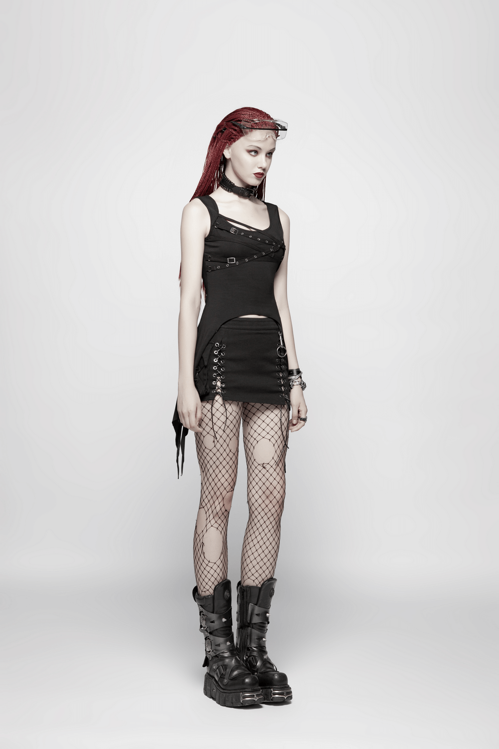 Stylish model in black punk long tank top with adjustable straps and fishnet tights for edgy fashion.