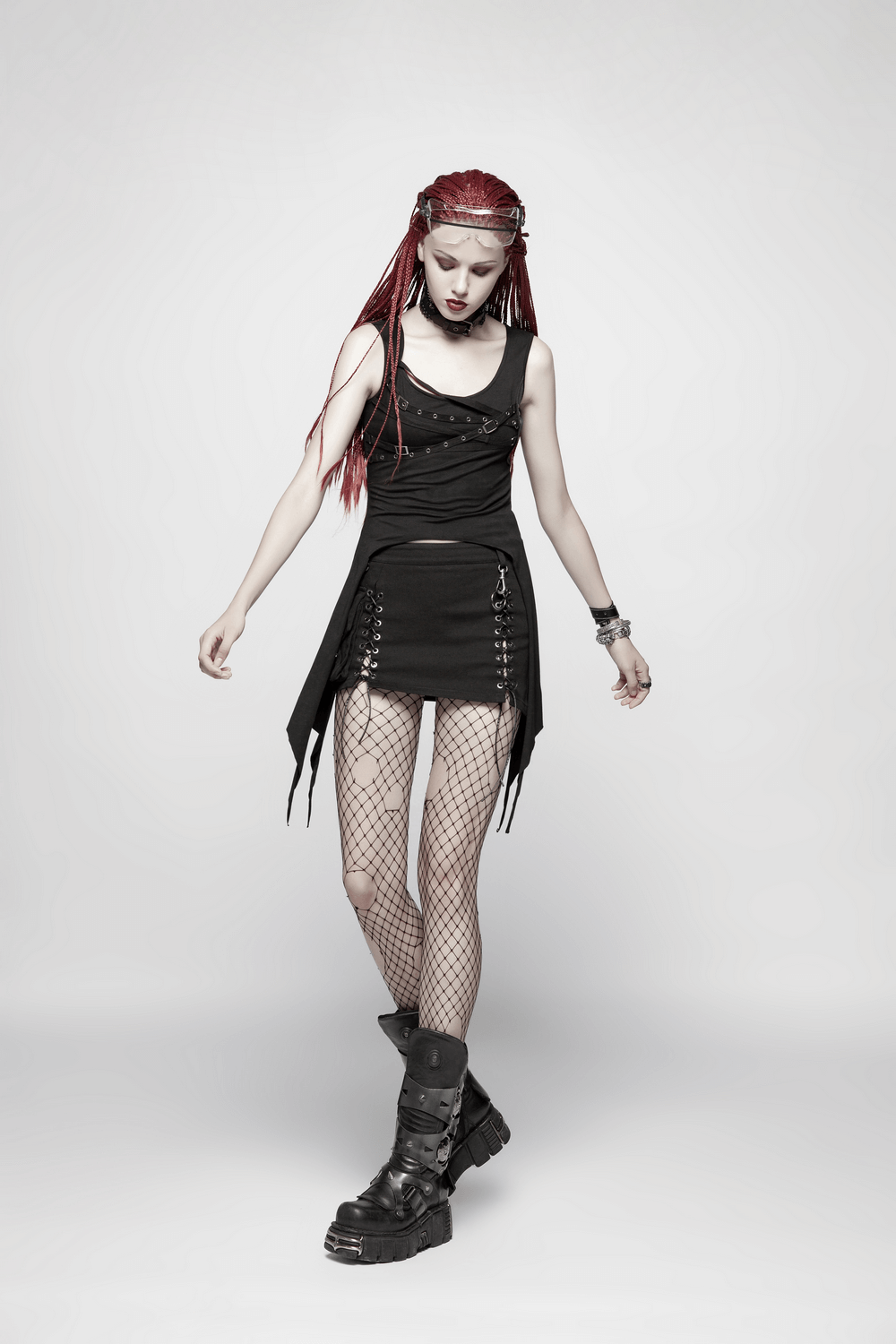 Stylish black punk tank top with adjustable straps and unique front decoration, paired with edgy accessories.