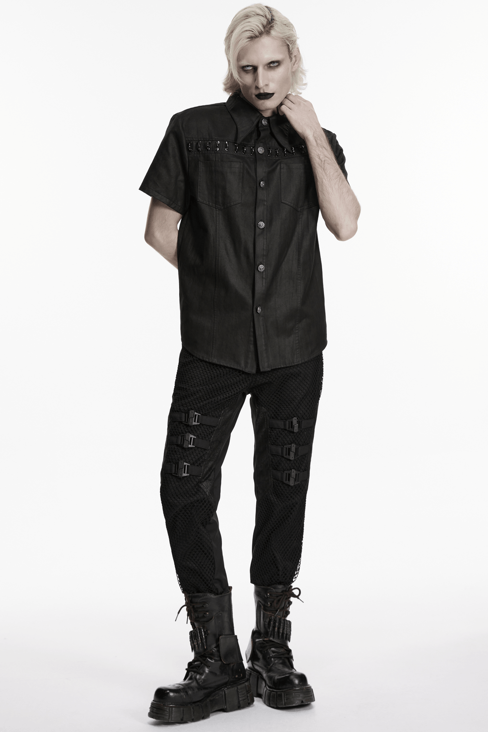 Model showcasing Black Punk Mesh Buckle Pants with Textured Front and a stylish black shirt.