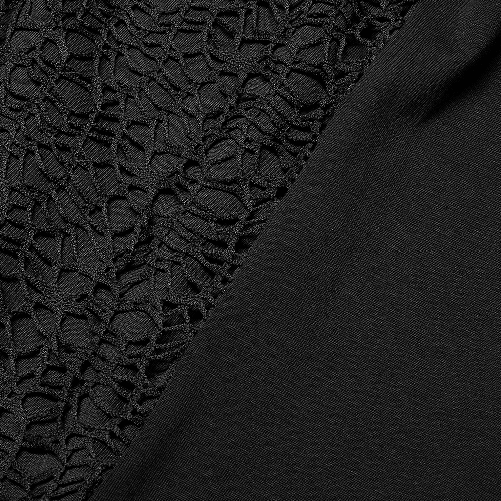Close-up of black punk mesh and knitted fabric showcasing the edgy design of a tank top.