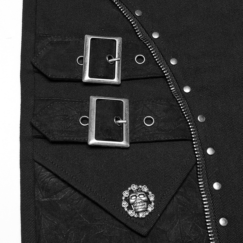 Close-up of black punk shorts featuring silver skull rivet, buckles, and edgy zipper detail.