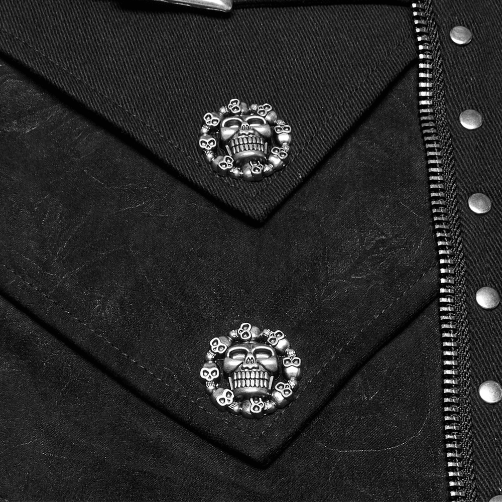 Close-up of punk shorts showcasing skull rivets and textured black fabric details.