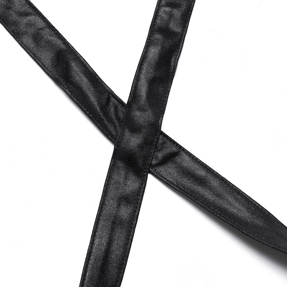 Close-up of black elastic cross straps from a punk style crop top, showcasing its edgy split design.