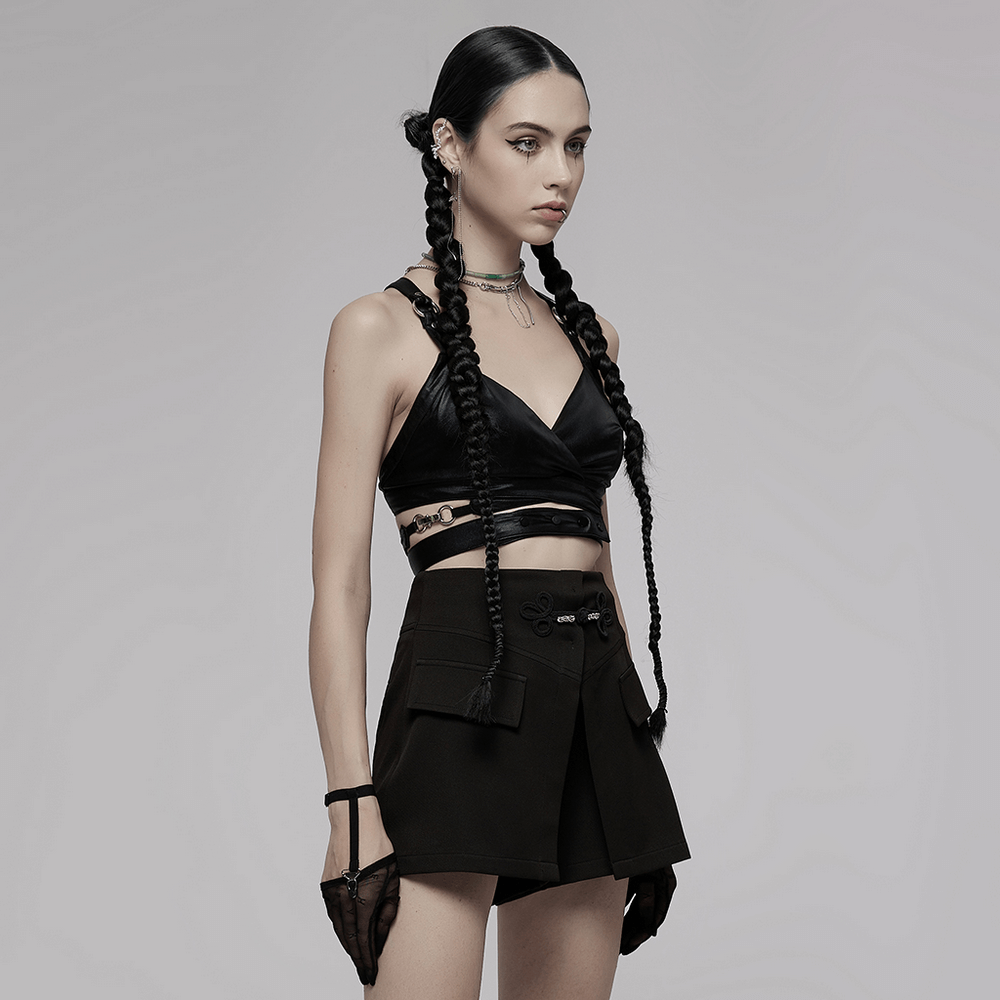 Model showcasing a black punk style crop top with criss-cross back and edgy accessories.