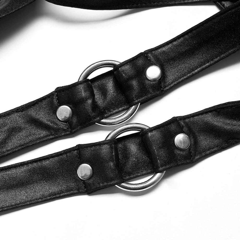 Close-up of black punk crop top's adjustable straps with metal rings and snaps for a stylish fit.