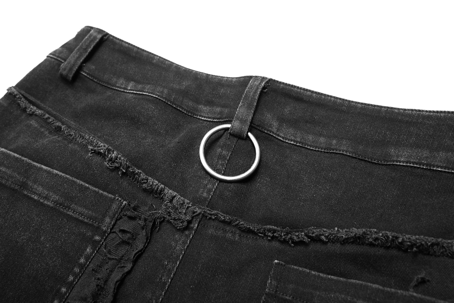 Close-up of black punk-style ripped jeans with raw edges and a metal ring detail for a trendy urban look.