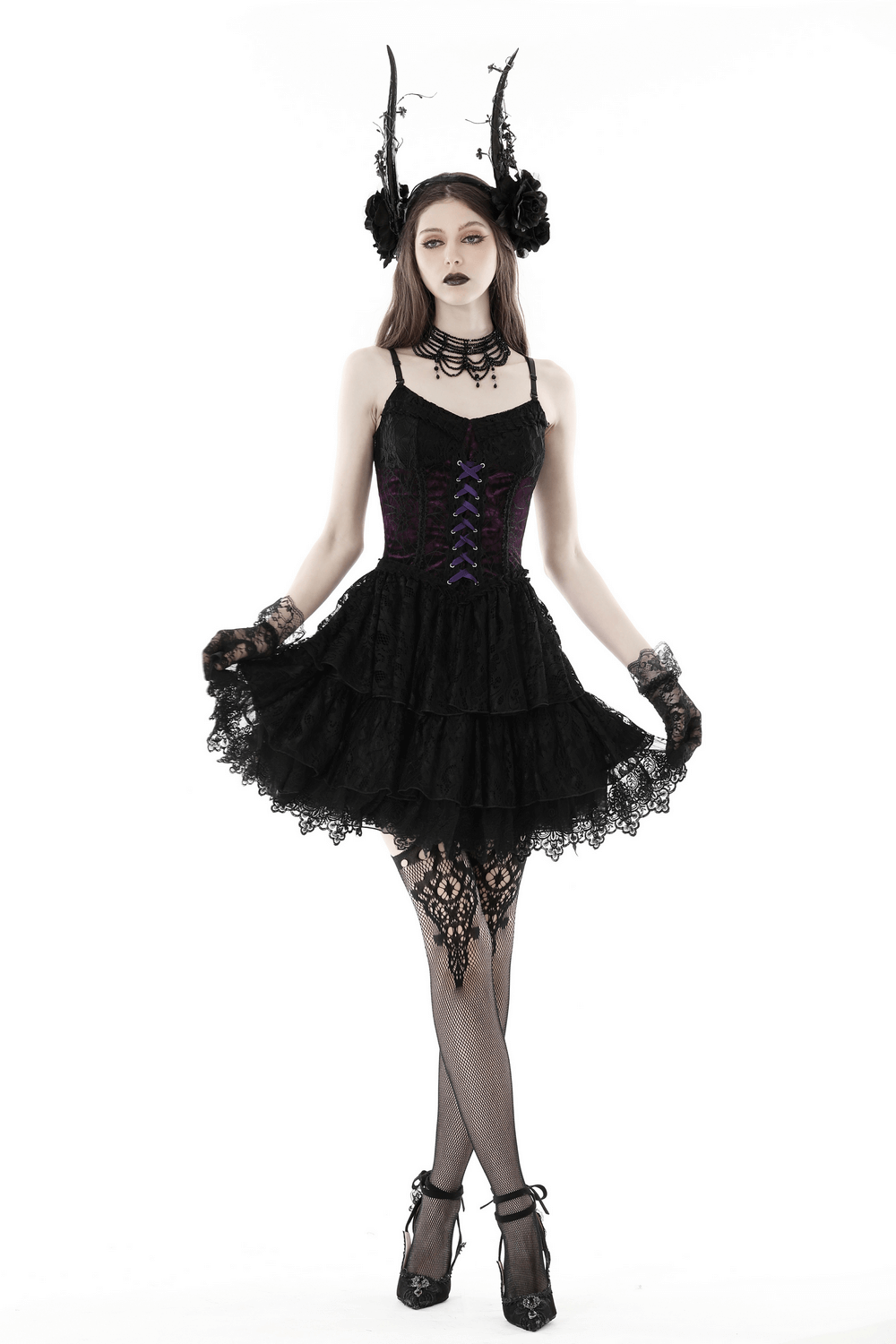 Gothic Lolita model wearing a black and purple lace-up mini dress with corset bodice and layered skirt.